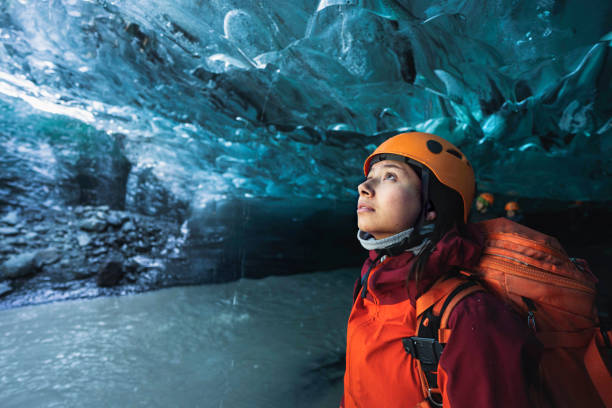 Female explorer in the ice cave, Iceland