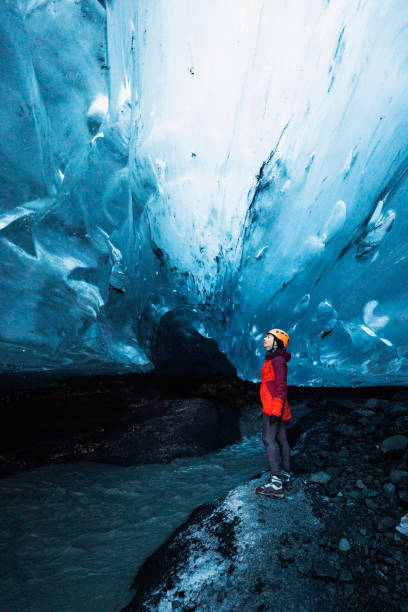 istock Female explorer in the ice cave, Iceland 2157378329