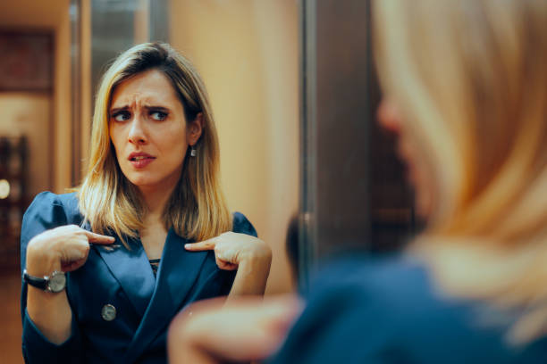 Businesswoman Looking in the Mirror Feeling Insecure