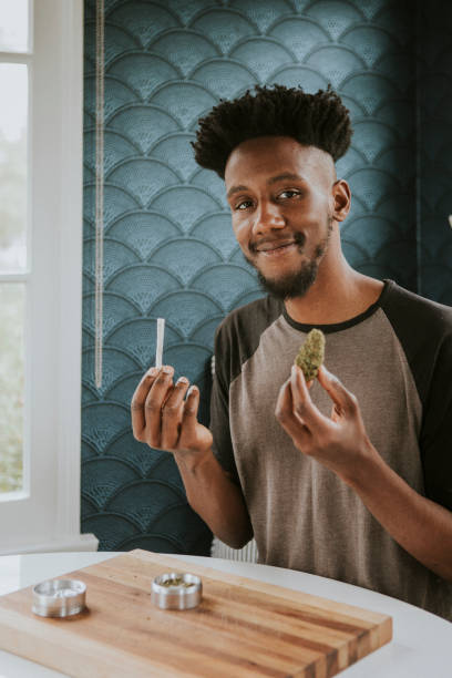 istock A man holding a joint and weed  in hand 2157379886