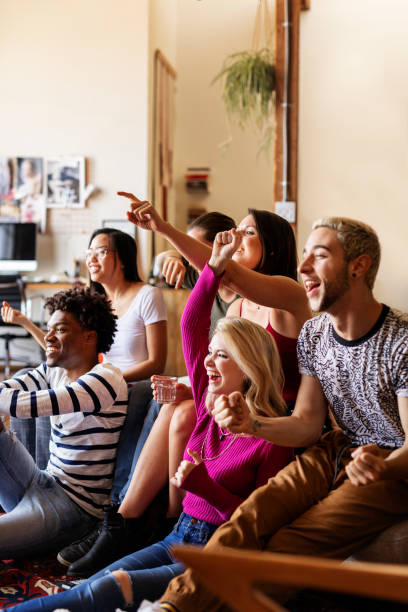 Friends watching a game show on the tv