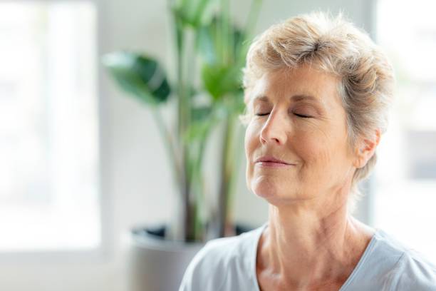 istock Senior woman doing Sukhasana pose 2157380113