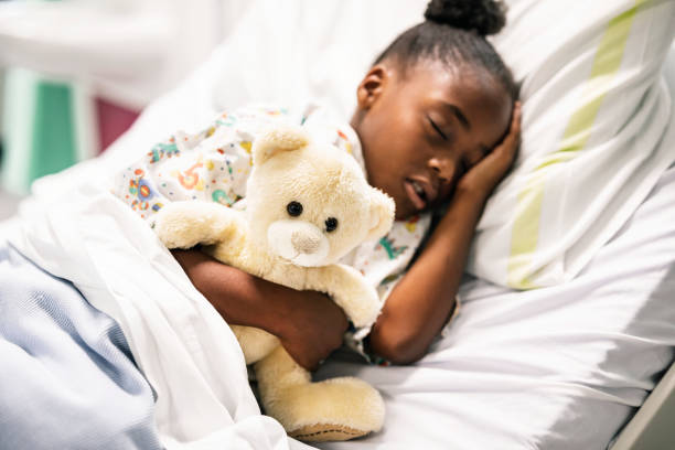 istock Little girl sleeping in a hospital bed 2157380119