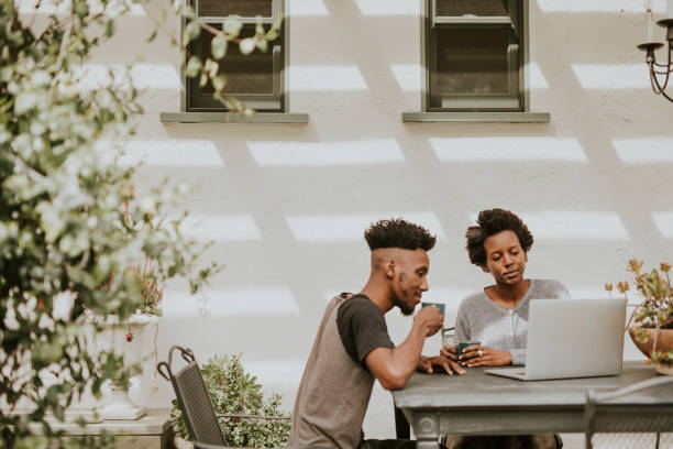 istock Black people drinking coffee and working on a laptop in the garden 2157380182