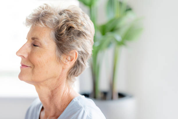 istock Senior woman doing Sukhasana pose 2157380221