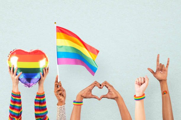istock LGBTQ+ pride celebration with hand and crowd cheering 2157381352