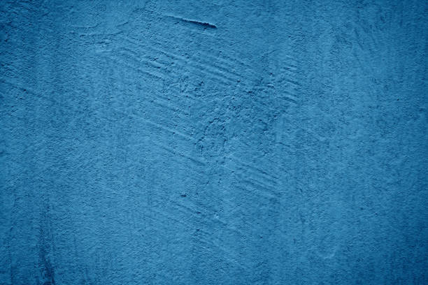 istock Dark blue rough grainy stone or concrete wall texture background 2157382287