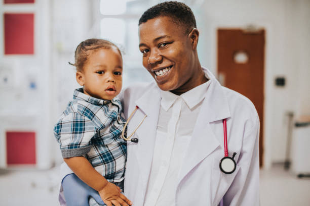 istock Happy pediatrician carrying a young boy 2157382433