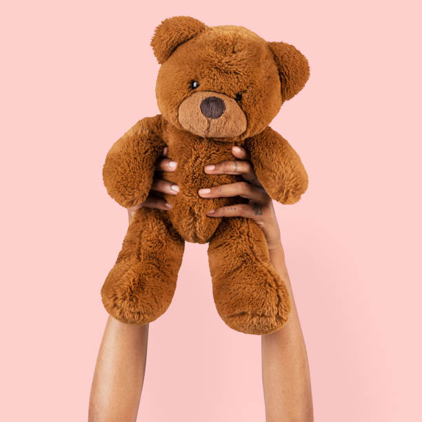 istock Teddy bear toy held by a hand for kids 2157382436