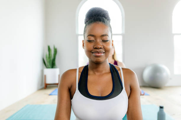 istock Black lady doing a Sukhasana yoga pose 2157383130