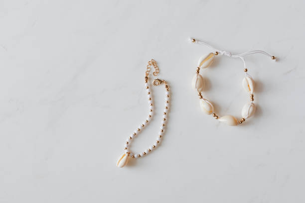 istock Seashell jewelries on white marble background 2157383319