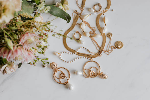 istock Gold jewelries with a flower bouquet 2157383331