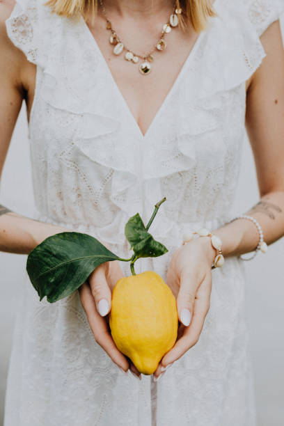 istock Woman holding a fresh lemon 2157383660