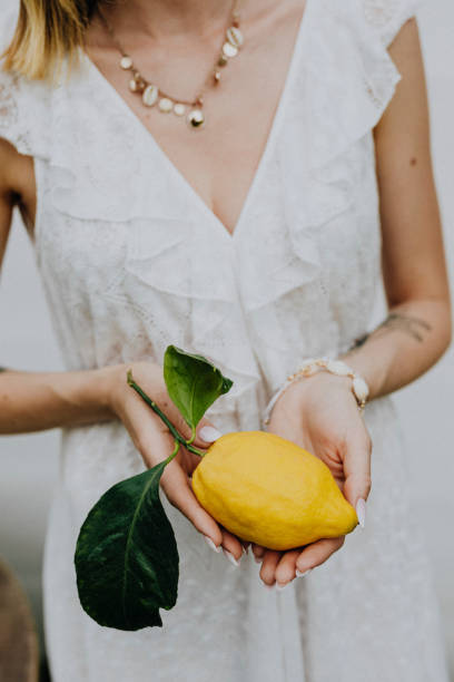 istock Woman holding a fresh lemon 2157383661