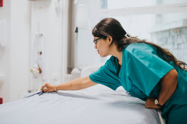 istock Nurse making the bed at a hospital 2157383670