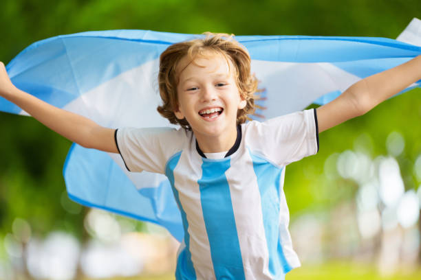 istock Child running with Argentina flag. Argentinian fan 2157384539