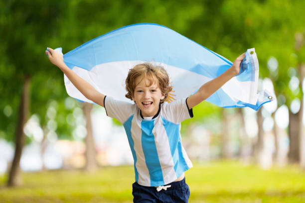 istock Child running with Argentina flag. Argentinian fan 2157384753