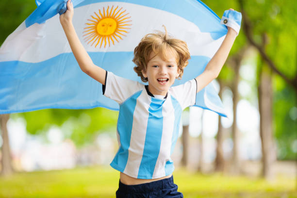istock Child running with Argentina flag. Argentinian fan 2157384845