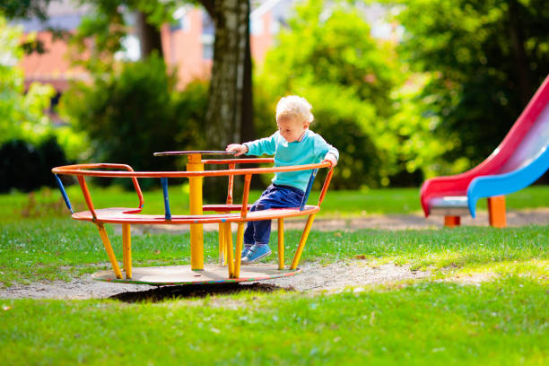 istock Kids explore nature. Children play in sunny park. 2157385028