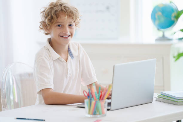 istock Child in school. Student in class. Boy at homework 2157386035