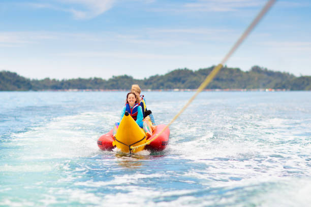 istock Banana boat ride. Kids on the beach. 2157386113