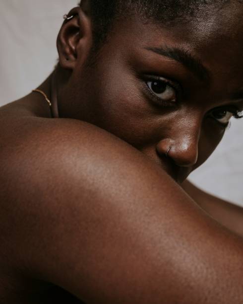 istock African woman looking over bare shoulder photo 2157387614