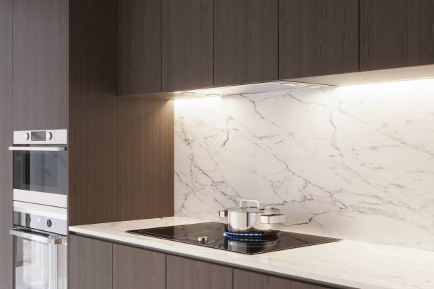 istock A kitchen with a sculptural range hood and marble backsplash. LED light 2157387994