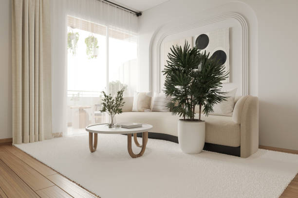 istock Empty white walled living room with couch, plants, and table. 2157389937