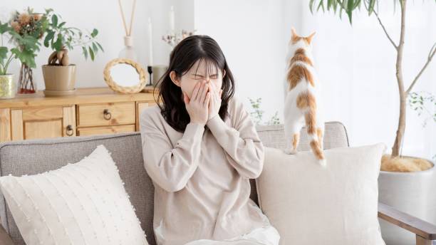 istock A woman sneezing and holding her mouth 2157391209
