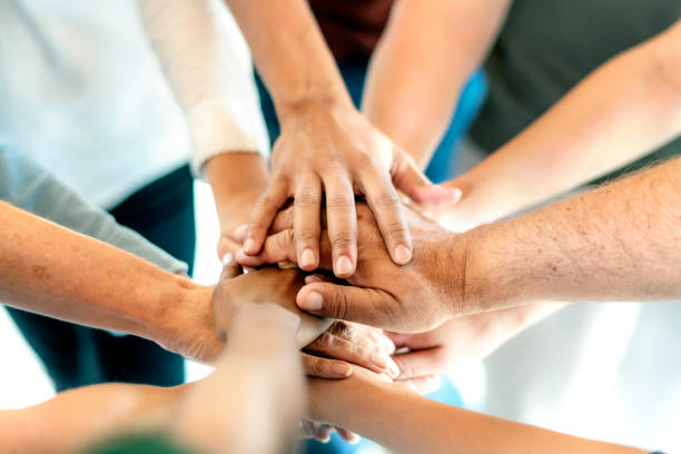istock Group of diverse people stacking hands in the middle 2157393520