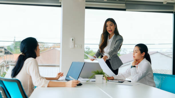 istock Businesswomen in Meeting Discussing Documents 2157394028
