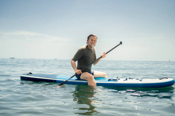 istock Mature man paddle boarding in the sea 2157394438