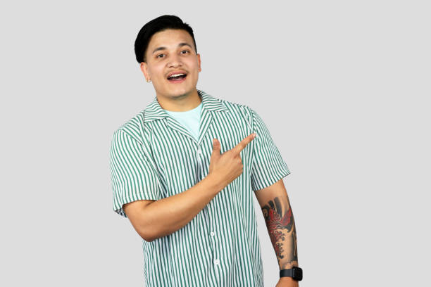 istock Asian Young Student Entrepreneur Giving Expressions and Making Gestures with Happy face Pointing 2157394573