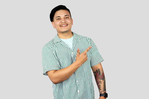 istock Asian Young Student Entrepreneur Giving Expressions and Making Gestures with Happy face Pointing 2157394623