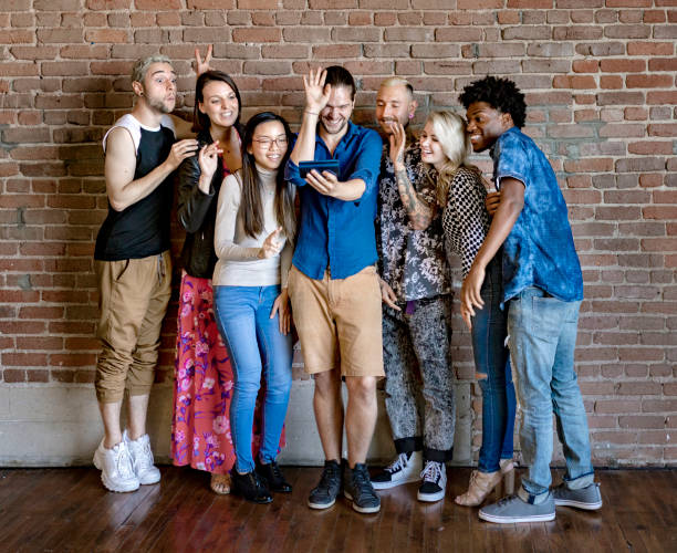 istock Happy friends being funny and video calling someone 2157395829