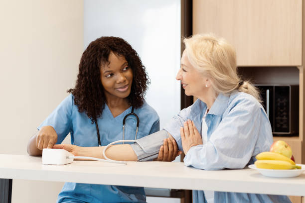 istock Nurse Checking Senior Woman's Blood Pressure at Home 2157397710