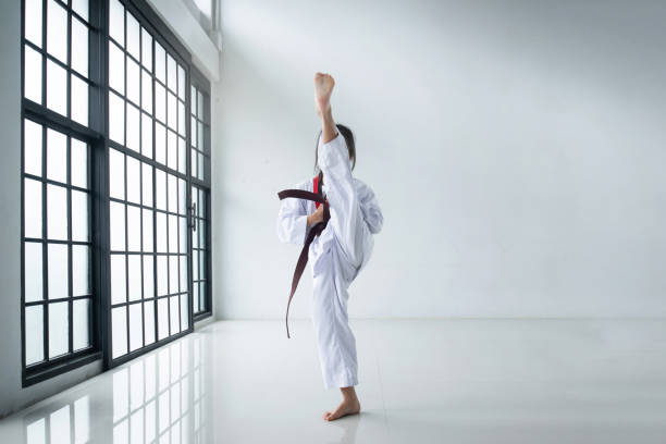 istock Little girl practicing Taekwondo, show a strong kick, Martial arts training in training studio 2157397878