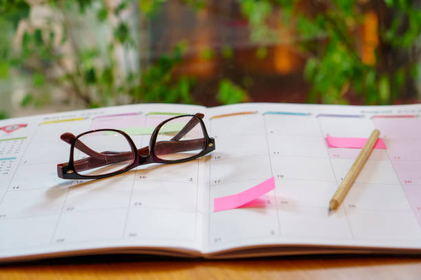 istock Diary,Calendar and agenda for Planner to plan timetable,appointment,organization,management on table.Desktop Calender 2024,laptop and cup of coffee place on wooden office desk.Calendar Concept 2157398088