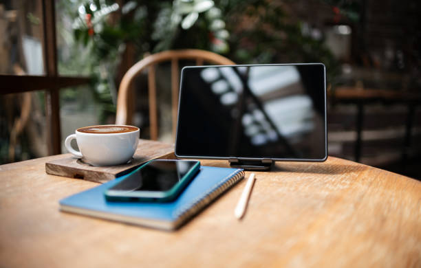 istock tablet and coffee cup on wooden table 2157399298