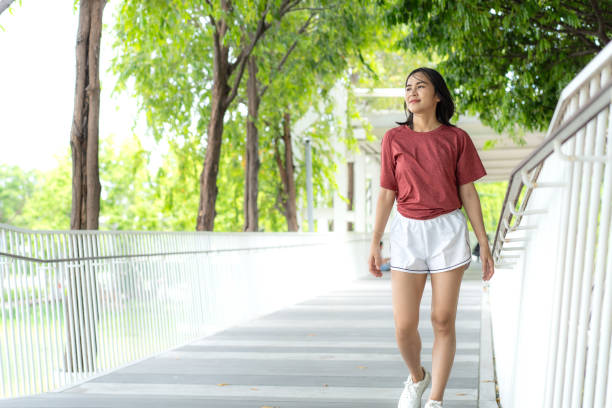 istock Young Asian woman exercising jogging outdoors in park. Copy space. 2157401600