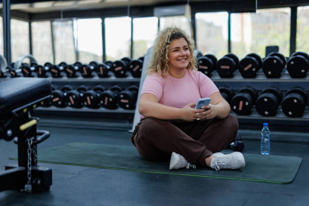 istock Curly-Haired Woman Relaxing with Smartphone 2157402027