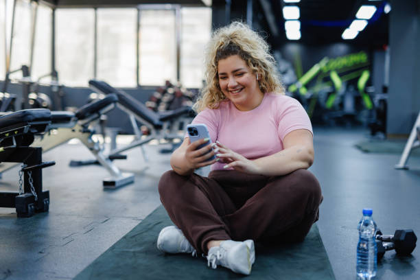 Woman Checking Phone During Gym Break