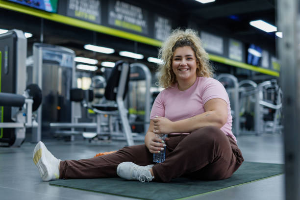 Young woman hydrating during gym workout
