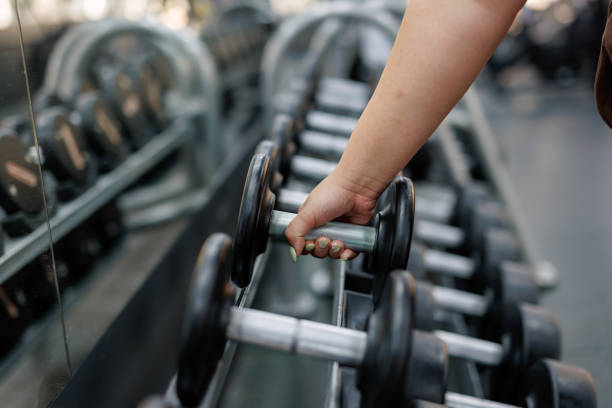 istock Hand reaching for a weight in gym setting 2157402796