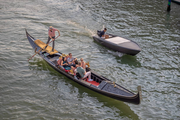 traditional Venetian gondola navigates the Grand Canal in Venice
