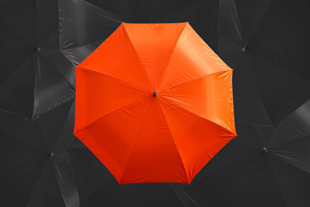 istock the orange umbrella on the dark background 2157403576