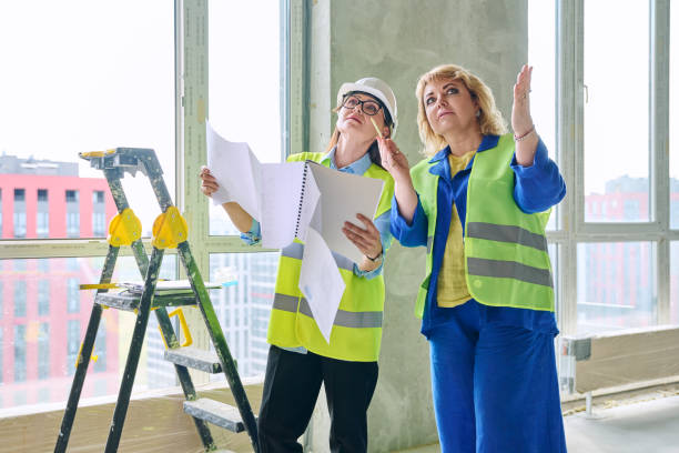 istock Two female industrial workers at construction site discussing work plans 2157406667