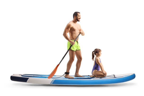istock Man with a child on a sup board 2157407040