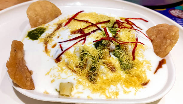 istock Famous Indian Dahi vada or dahi bhalla chaat served with papdi and sev and chatni. 2157407622