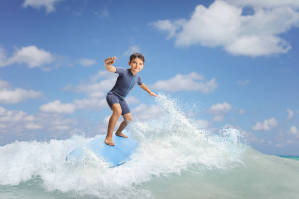 istock Full length portrait of a boy riding a surfboard 2157407882